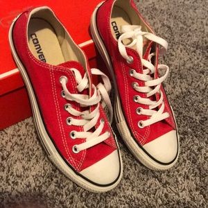 A pair of red low converse.